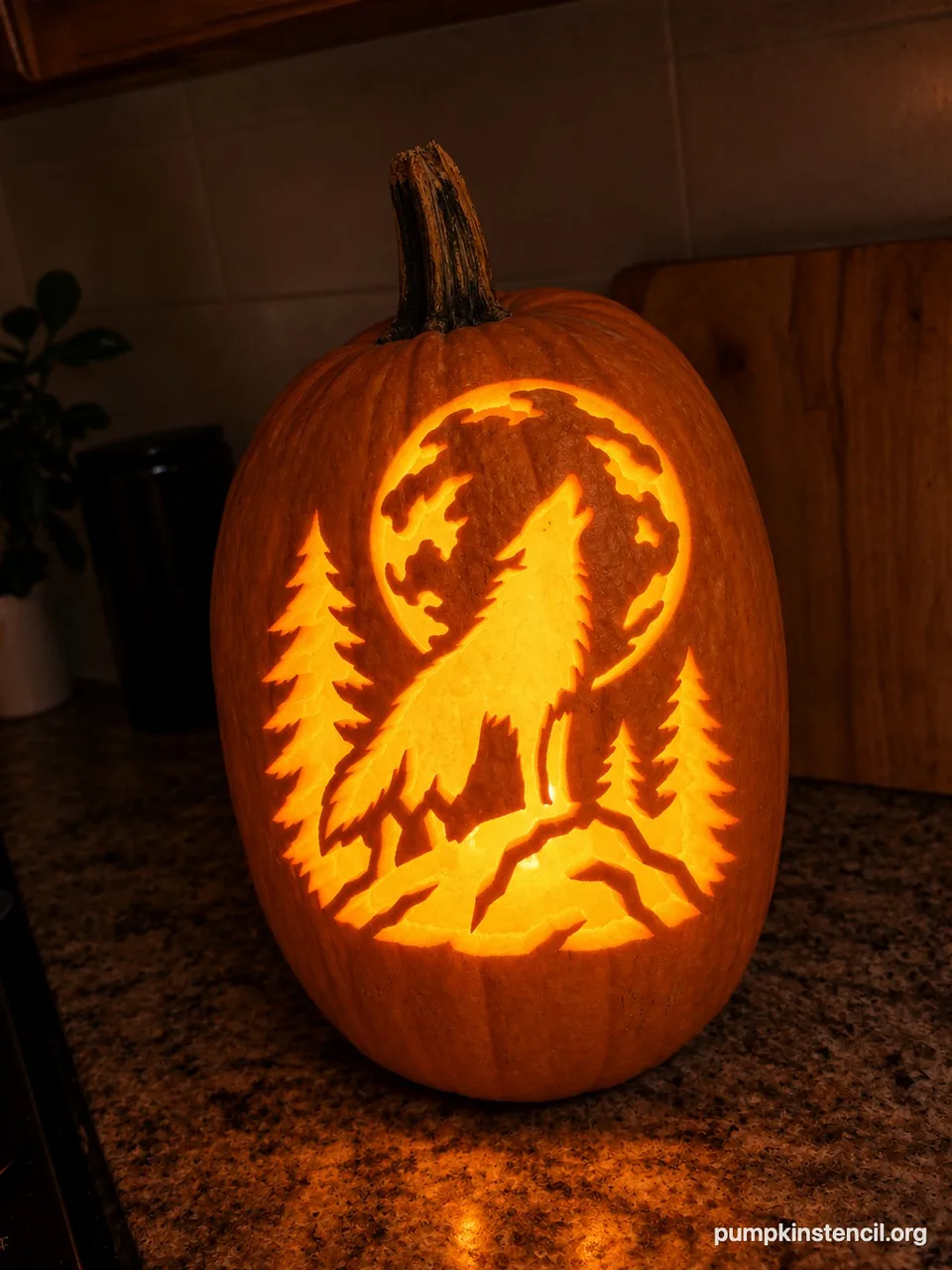 The same tall pumpkin carved with a howling wolf under a full moon, lit from inside